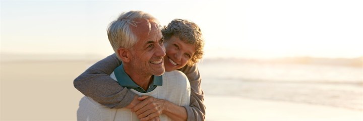 Mature couple smiling on the beach
